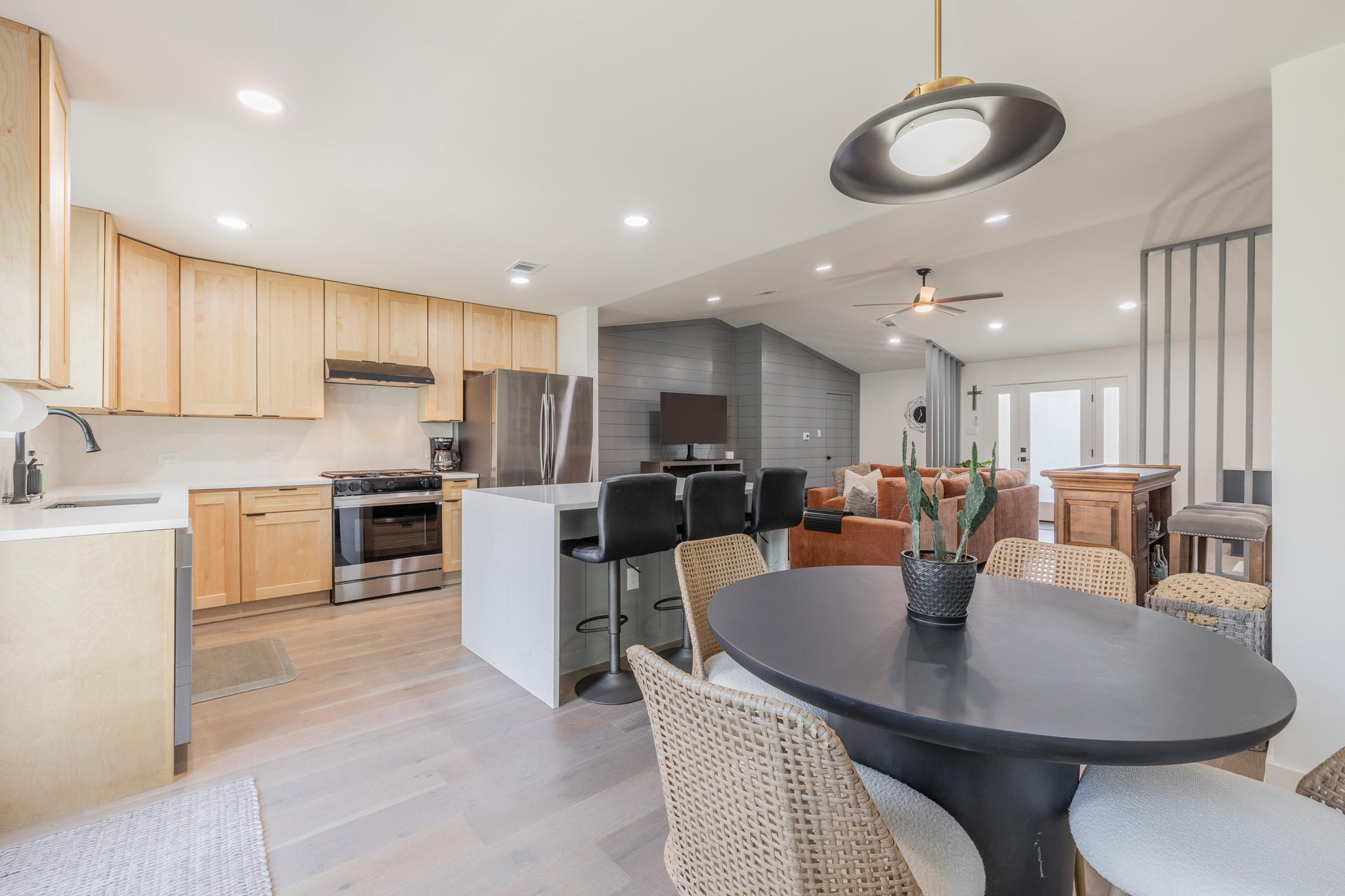 2214 Lear Lane Austin, TX 78745 - Photo 17 of 40 a kitchen with a dining table chairs sink and microwave