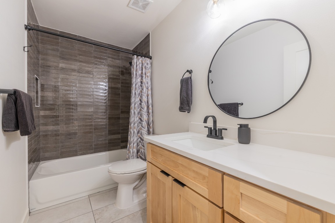 2214 Lear Lane Austin, TX 78745 - Photo 20 of 40 a bathroom with a sink a toilet and a mirror