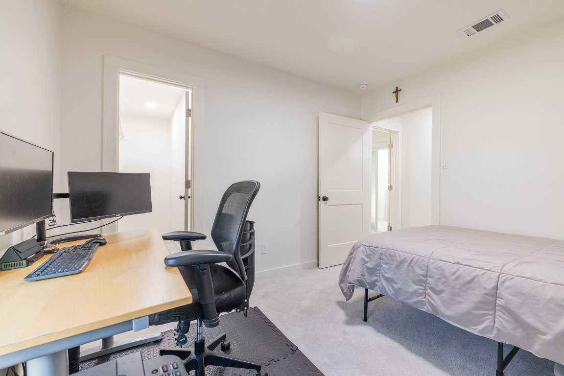 2214 Lear Lane Austin, TX 78745 - Photo 22 of 40 a bedroom with a workspace
