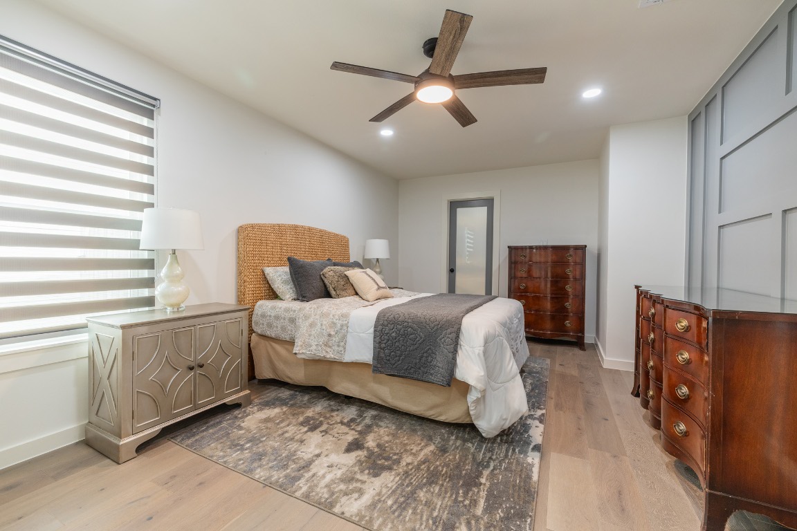 2214 Lear Lane Austin, TX 78745 - Photo 28 of 40 a spacious bedroom with a bed and a dresser with the outer view