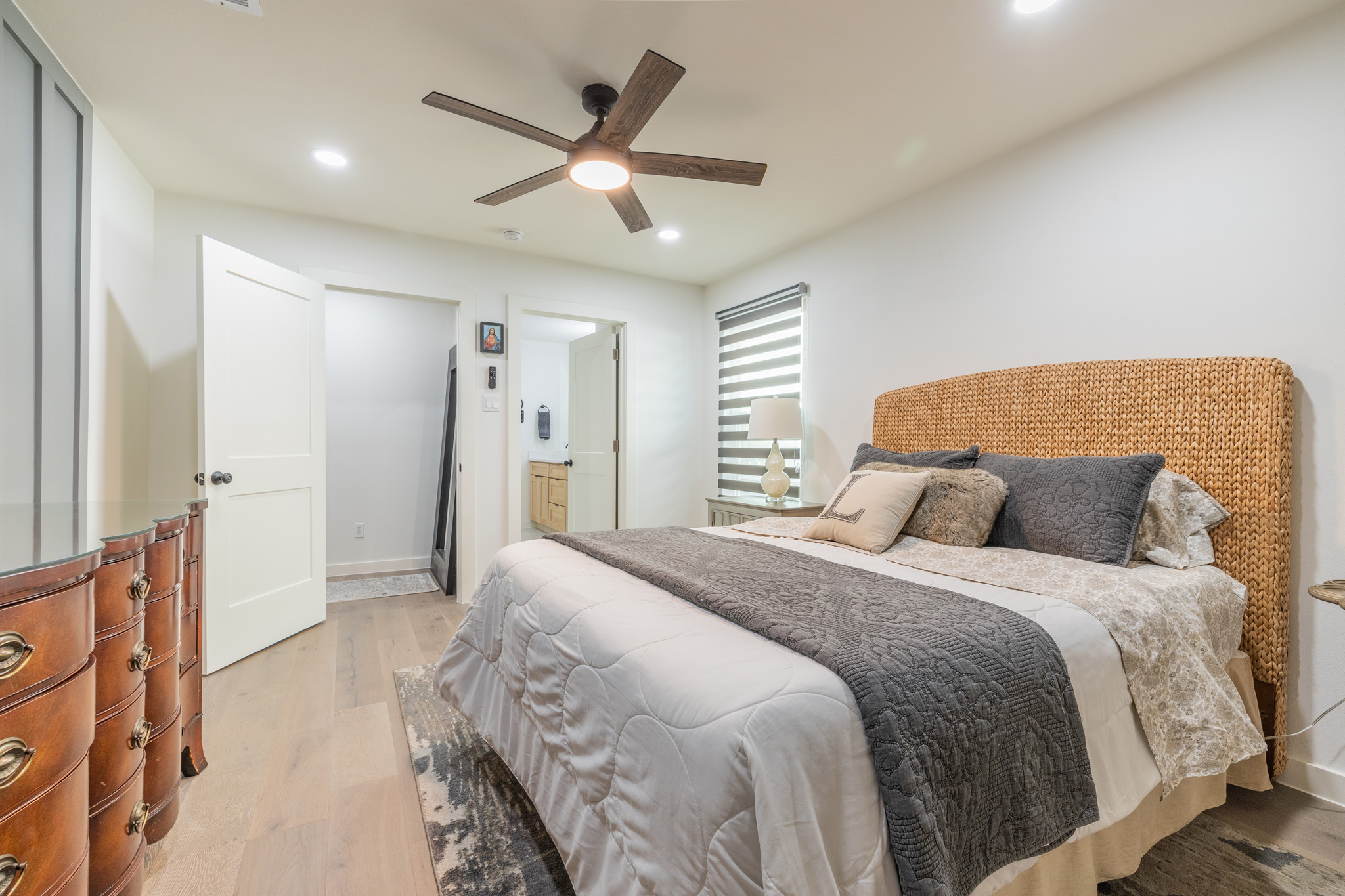 2214 Lear Lane Austin, TX 78745 - Photo 29 of 40 a spacious bedroom with a bed and a chandelier