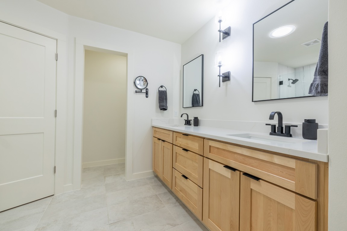 2214 Lear Lane Austin, TX 78745 - Photo 32 of 40 a spacious bathroom with a double vanity sink mirror and