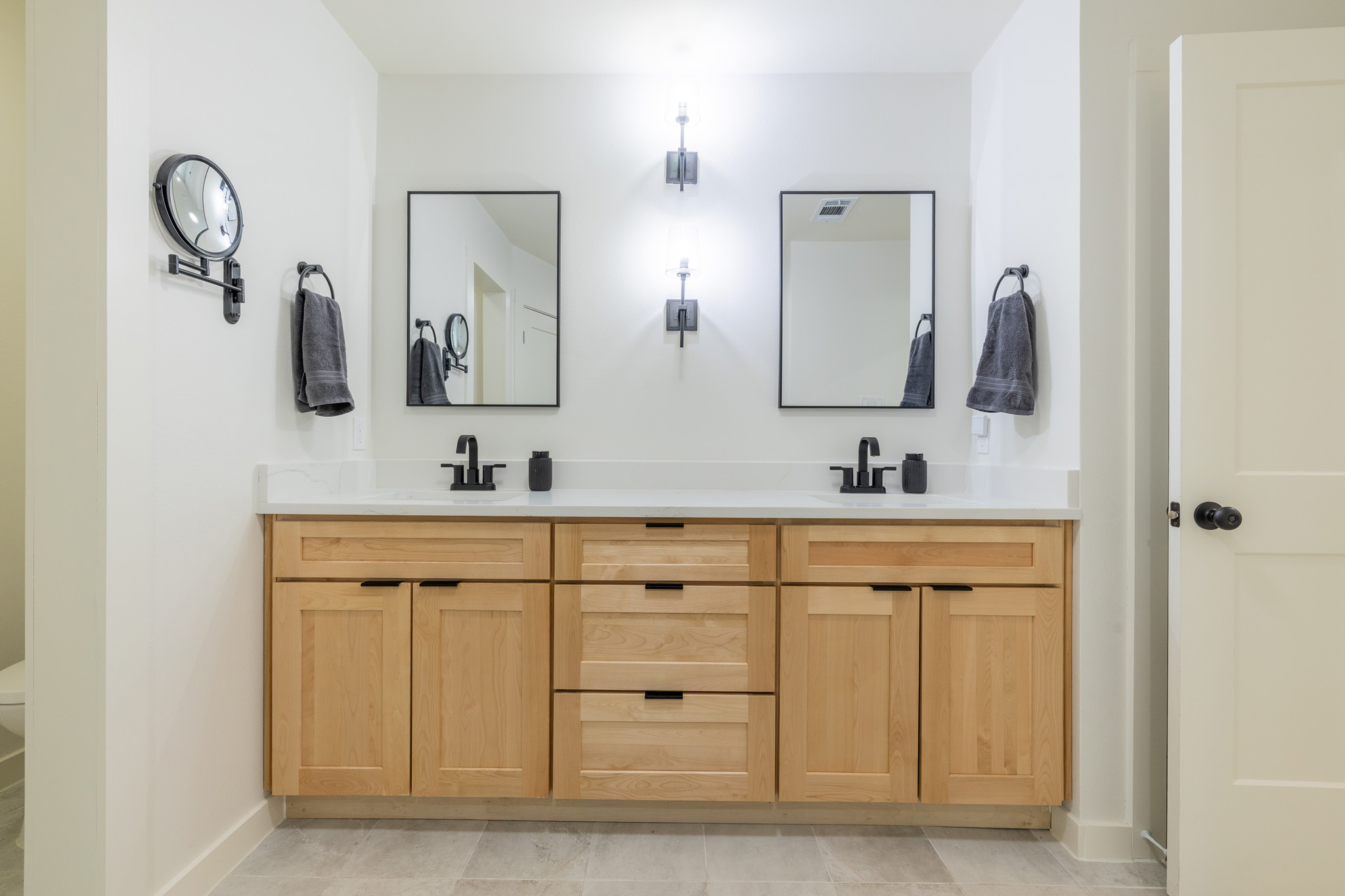 2214 Lear Lane Austin, TX 78745 - Photo 35 of 40 a bathroom with double vanity sinks and a mirror