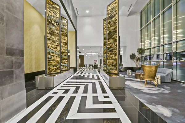 a room with lots of glass windows and furniture