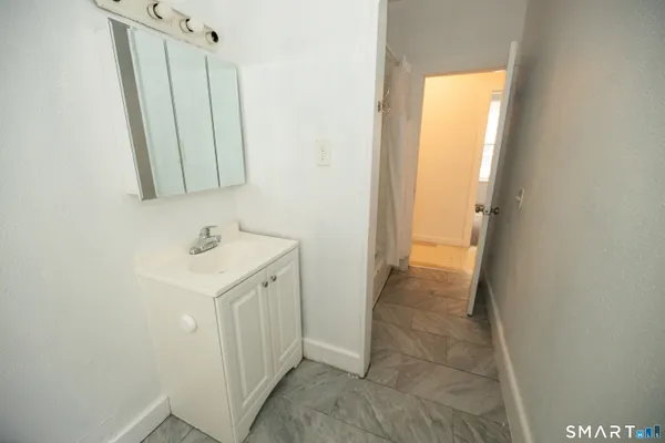 a bathroom with a sink a mirror and a shower
