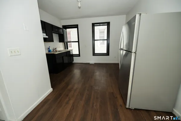 a view of a kitchen from a hallway