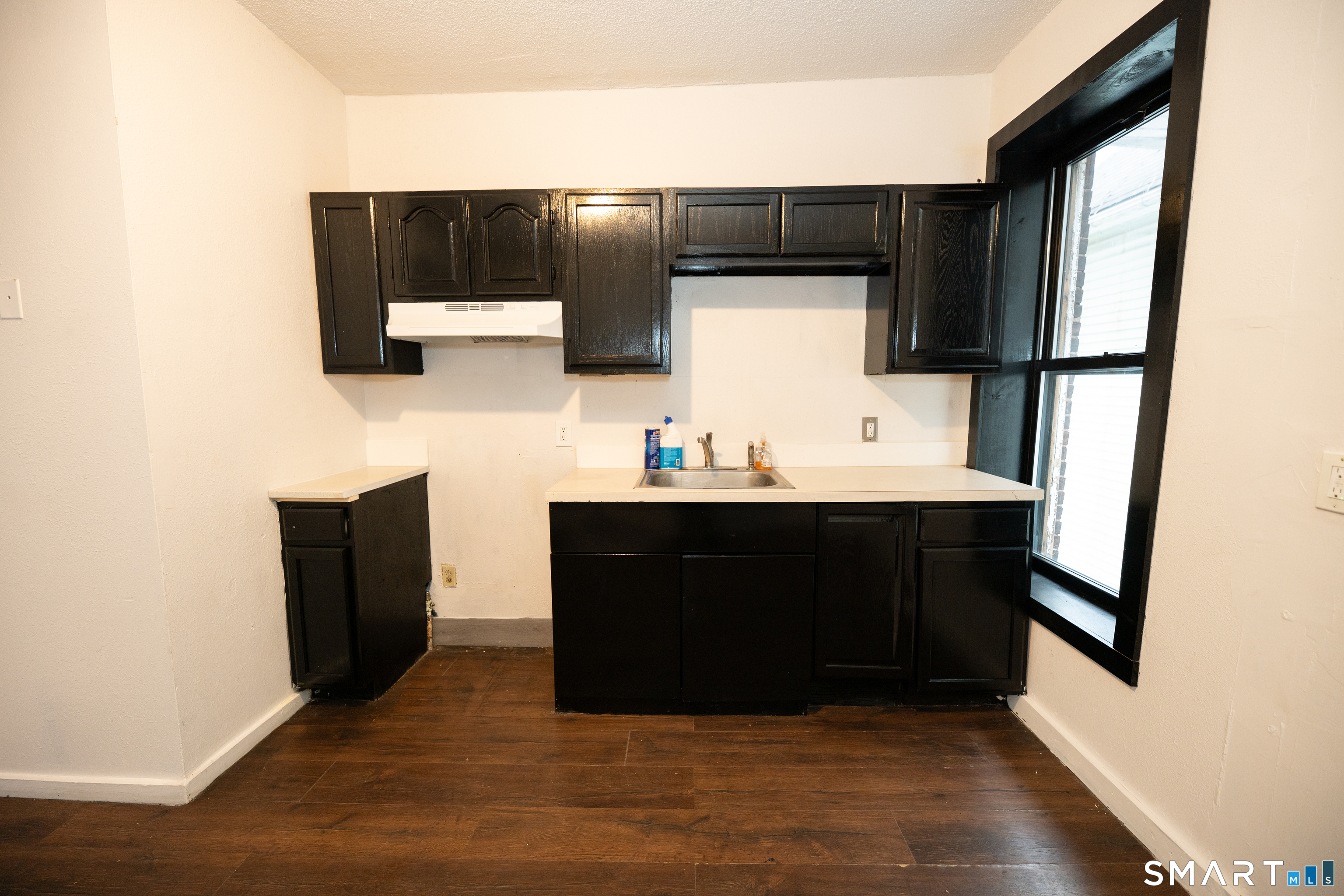86 Spring Street, Unit 2 West Haven, CT 06516 - Photo 4 of 27 a living room with a couch and a flat screen tv