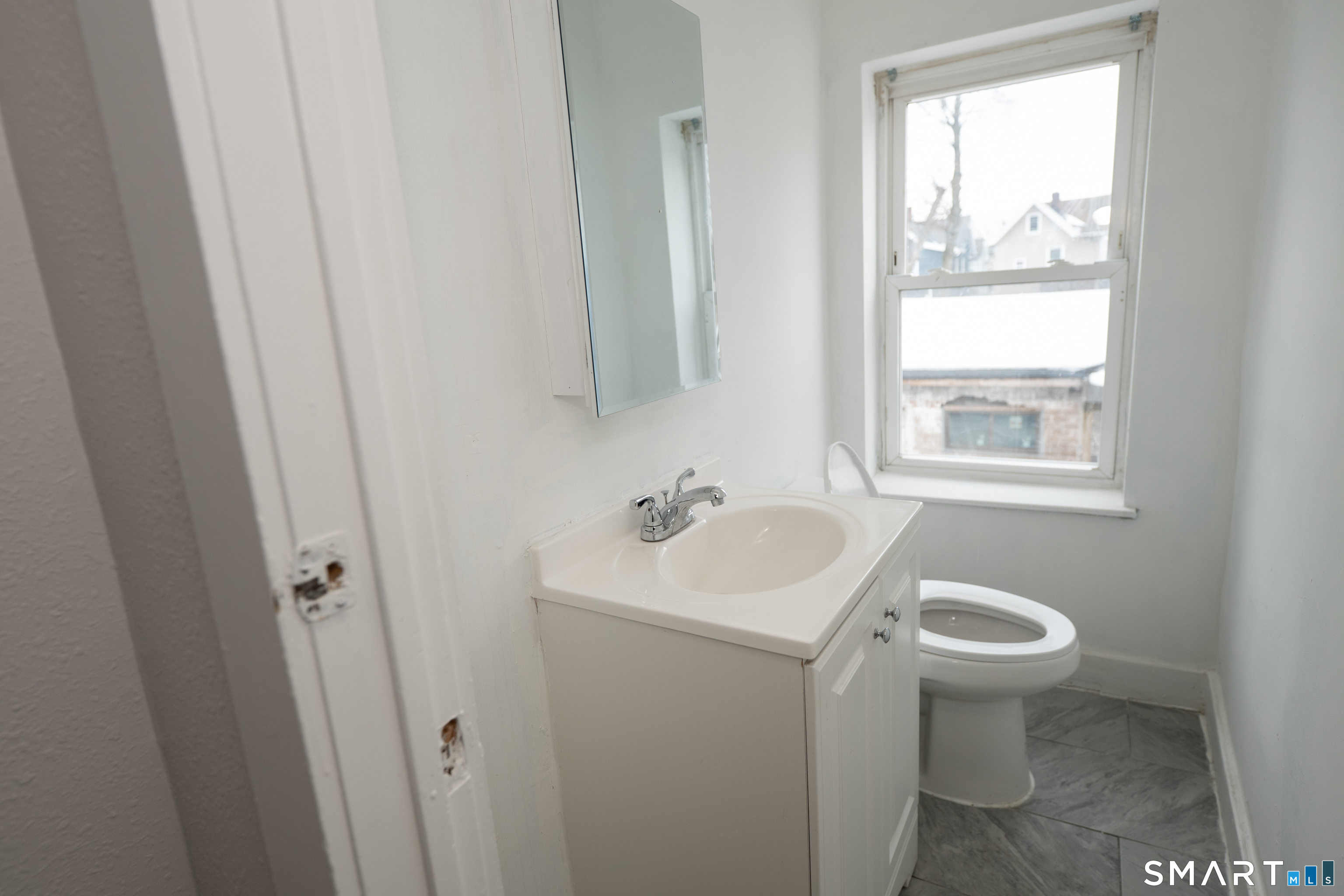 86 Spring Street, Unit 2 West Haven, CT 06516 - Photo 7 of 27 a bathroom with a sink toilet and a window