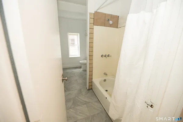 a bathroom with a granite countertop shower and a sink