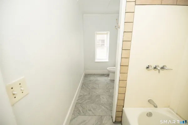 a bathroom with a bathtub and shower