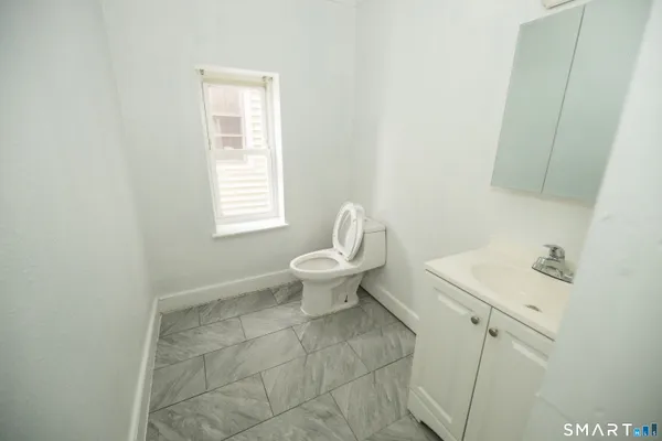 a bathroom with a toilet sink and window