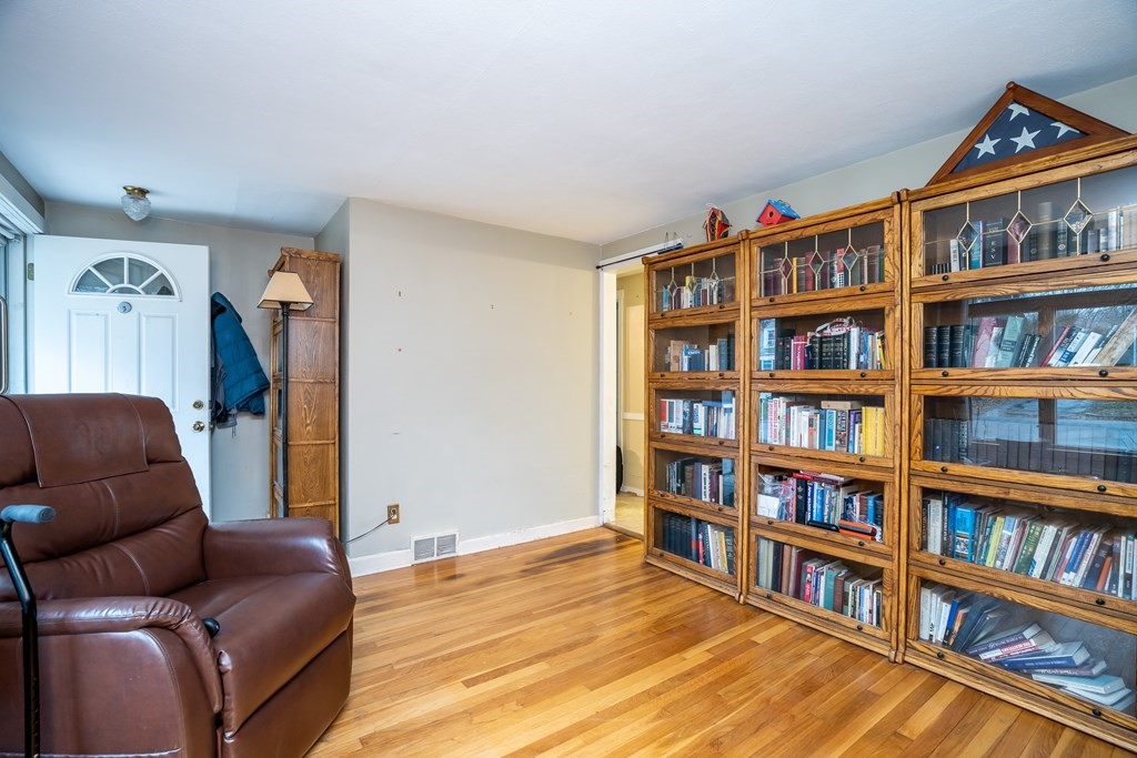 107 Mayflower Road Springfield, MA 01118 - Photo 12 of 32 a living room with furniture and a book shelf