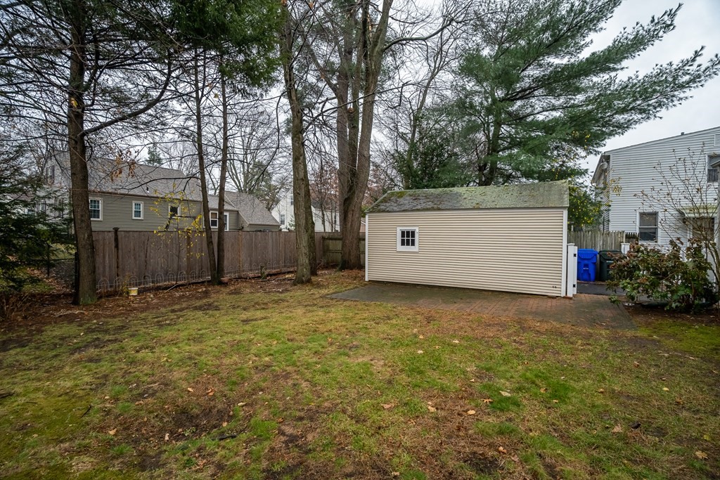 107 Mayflower Road Springfield, MA 01118 - Photo 8 of 32 a view of a backyard with large trees and a barn