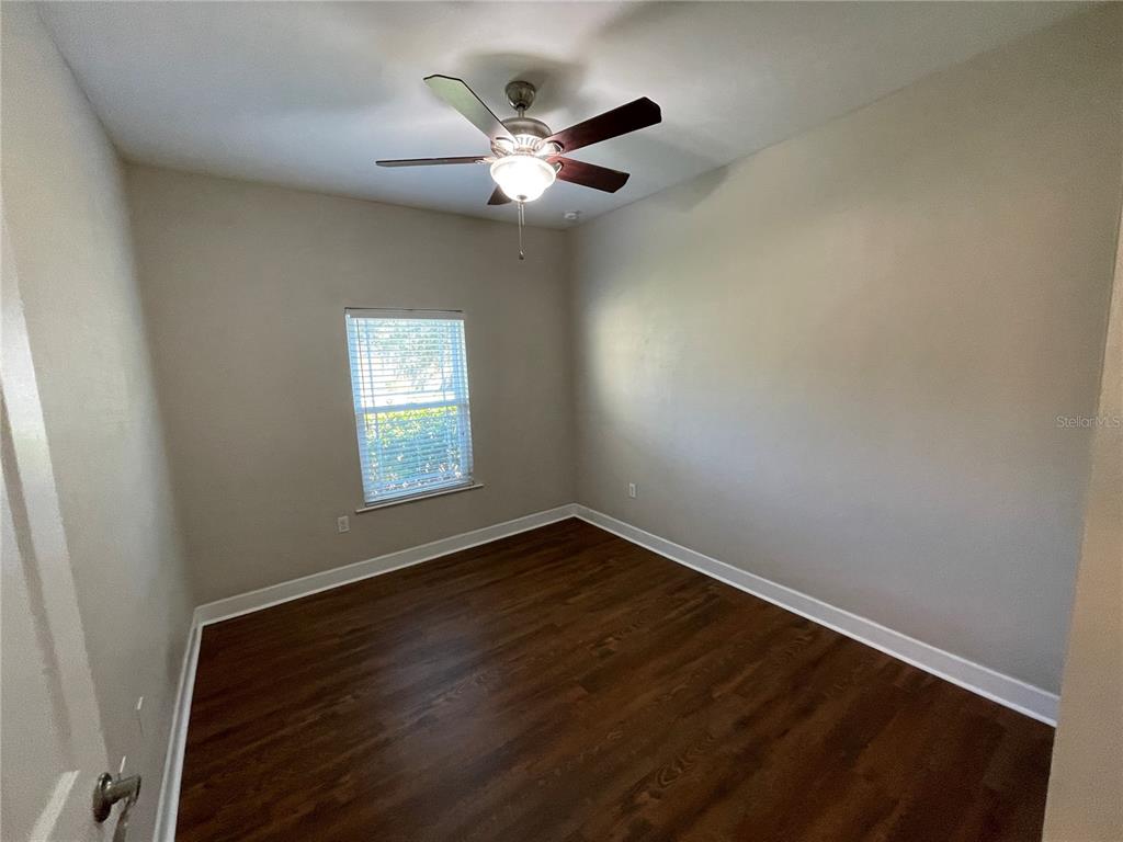 1604 Southwest 66th Drive Gainesville, FL 32607 - Photo 12 of 18 an empty room with wooden floor and windows