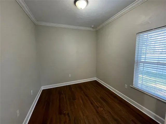 a view of a room with wooden floor and windows