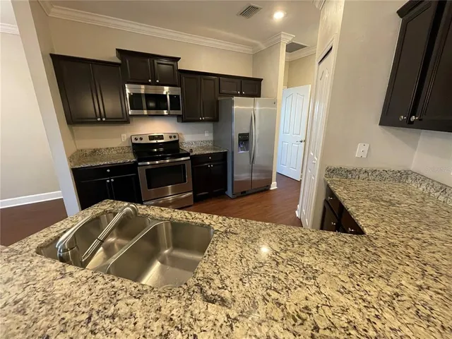 a kitchen with a sink stove and refrigerator