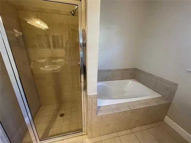 a bath tub sitting next to a shower