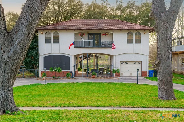 a front view of house with yard and outdoor seating