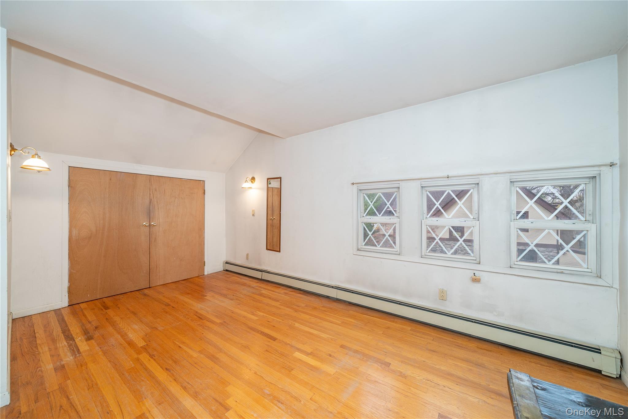 1259 Post Road Scarsdale, NY 10583 - Photo 18 of 20 a view of an empty room with window and wooden floor