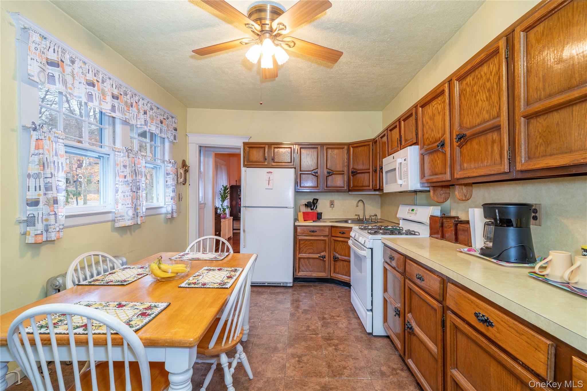1259 Post Road Scarsdale, NY 10583 - Photo 8 of 20 a kitchen with stainless steel appliances granite countertop a sink a stove a refrigerator a stove a dining table and chairs with wooden floor