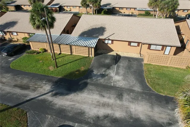 an aerial view of a house with outdoor space and sitting area