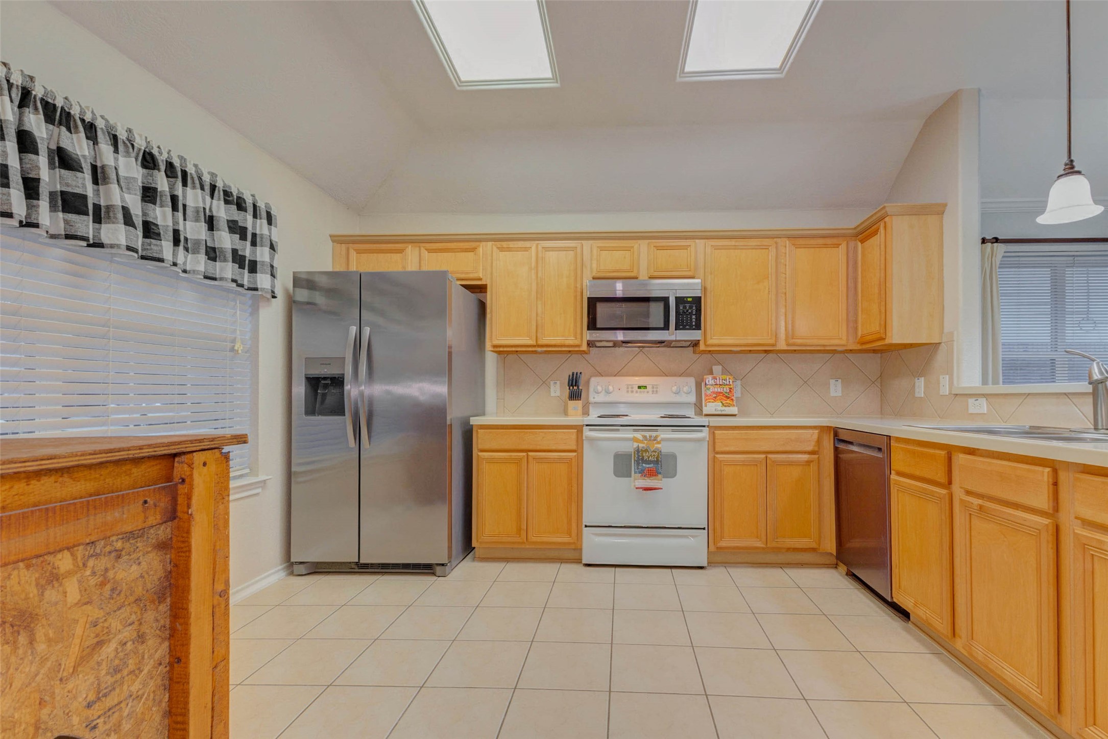 2326 Fern Lacy Drive Spring, TX 77388 - Photo 12 of 31 Bright kitchen with abundant cabinetry, generous counter space, and natural light from overhead skylights.