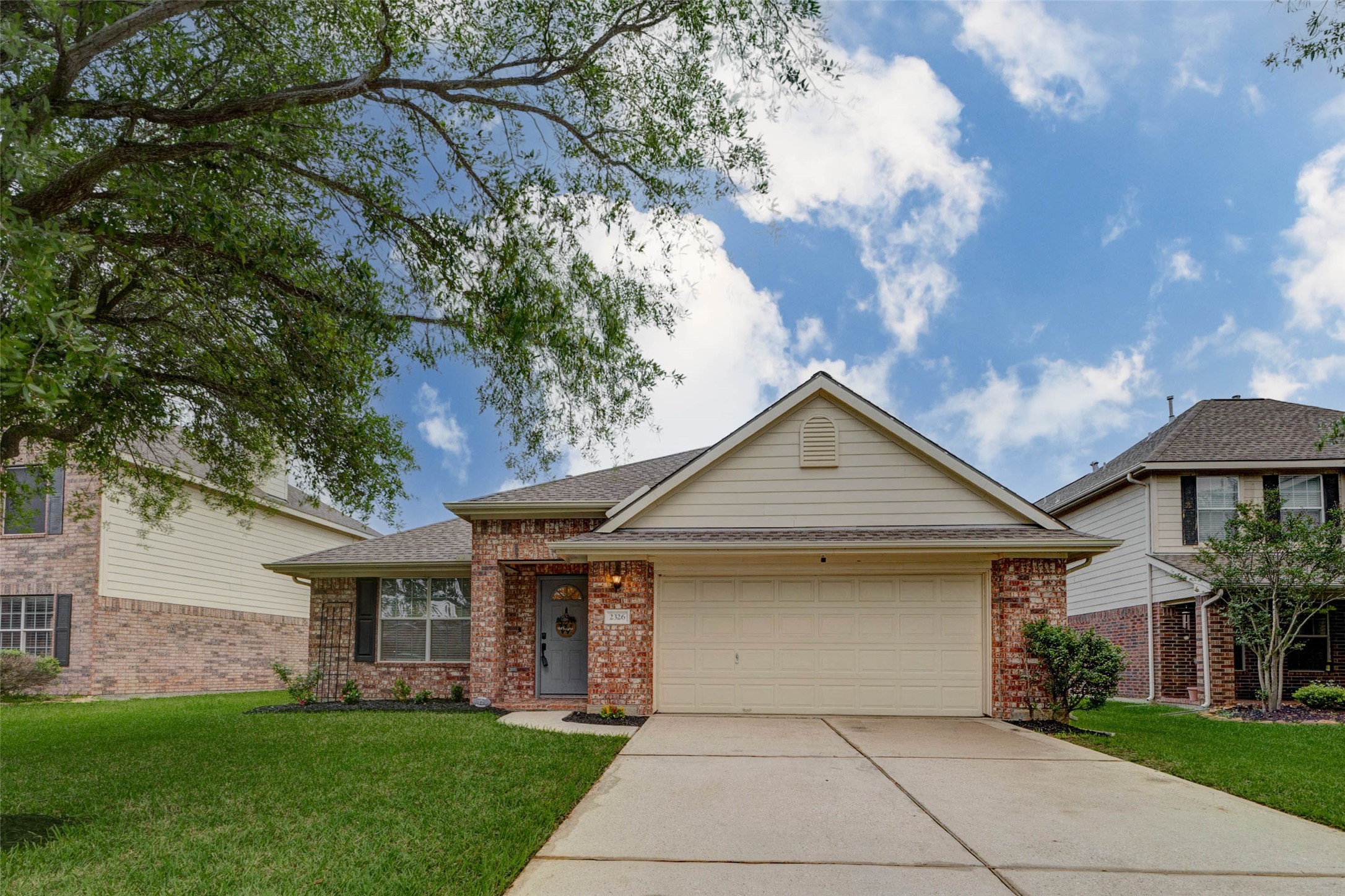 2326 Fern Lacy Drive Spring, TX 77388 - Photo 3 of 31 Attractive front elevation with private driveway, attached garage, and mature shade trees.