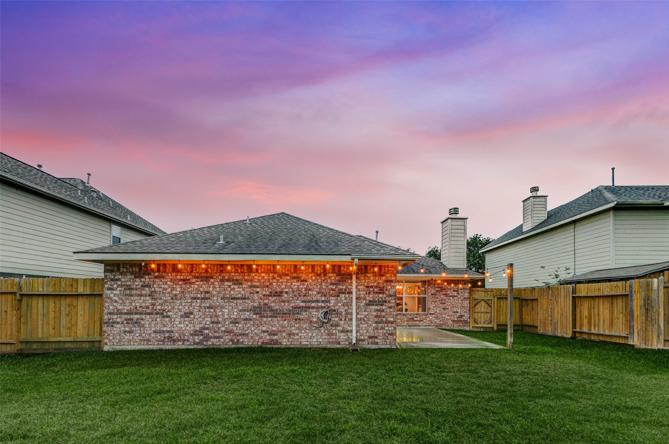 2326 Fern Lacy Drive Spring, TX 77388 - Photo 31 of 31 Rear exterior at sunset showcasing expansive green space and inviting outdoor living.