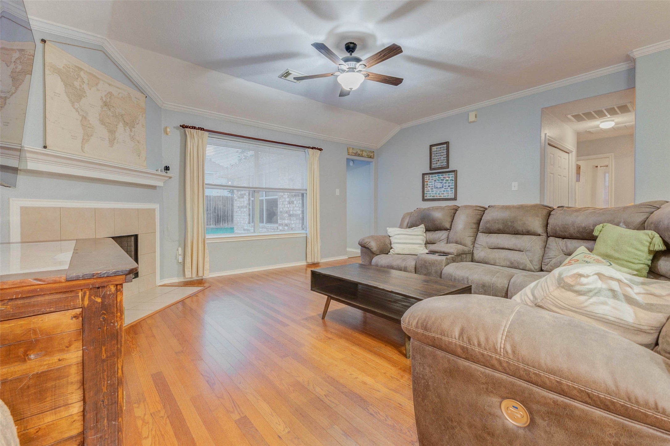 2326 Fern Lacy Drive Spring, TX 77388 - Photo 9 of 31 Spacious living room with fireplace, large window, and warm flooring throughout.