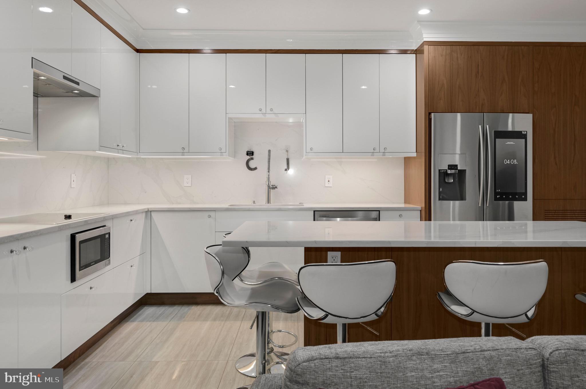 729 Kenyon Street Northwest Washington, DC 20010 - Photo 6 of 26 Sleek modern kitchen with elegant finishes.