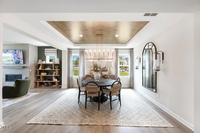 a spacious bedroom with a bed a couch and a chandelier