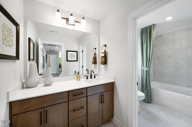 view of a wooden floor with a white table and chairs