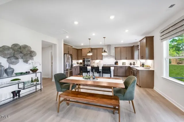 a living room with furniture large window and a fireplace
