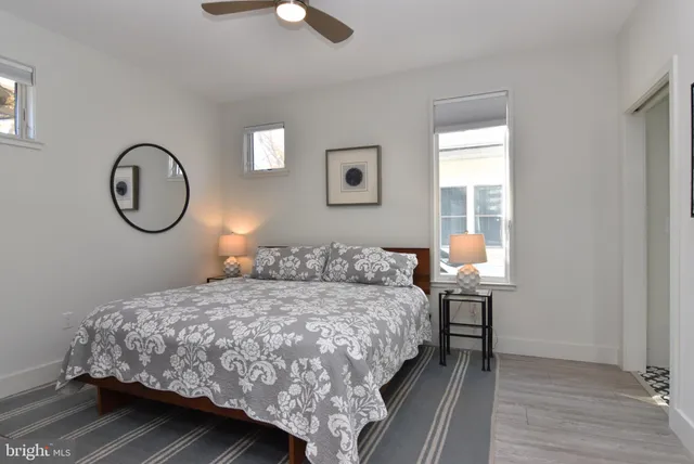 a bedroom with a large bed and a window