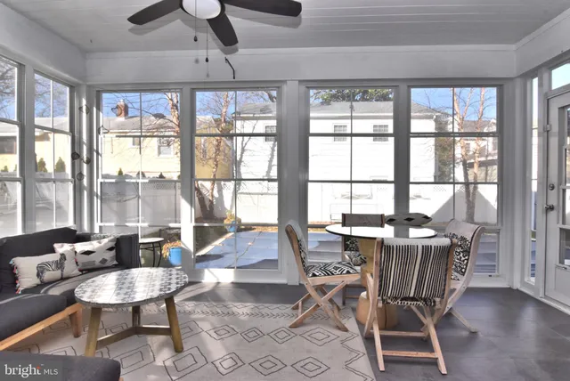 a large bed sitting in a bedroom next to a window and a chandelier