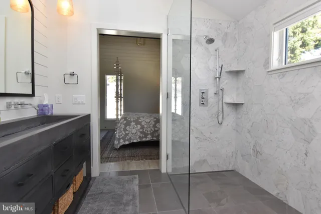 a bedroom with a large bed and a chandelier