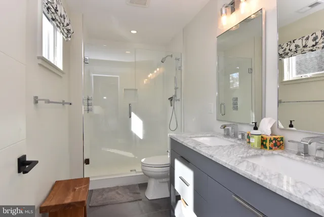 a bedroom with a bed and a flat tv screen on dresser