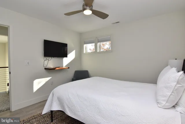 a bedroom with a bed and a window