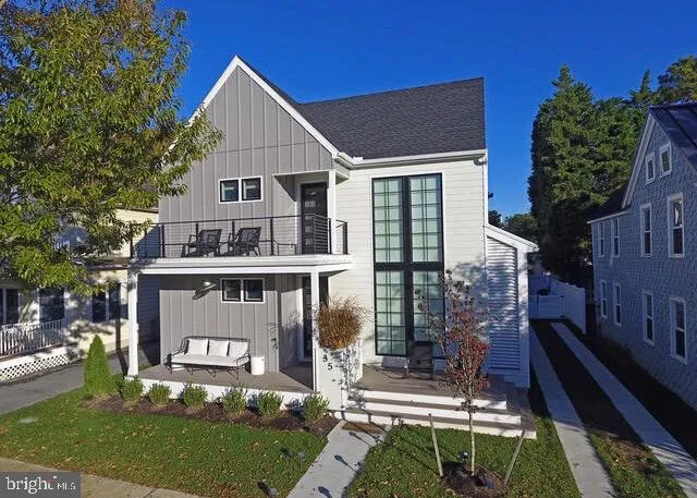 a view of house with a yard and potted plants