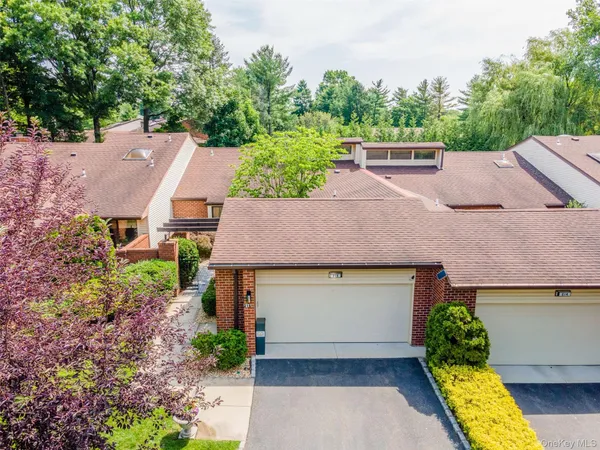 an aerial view of a house with swimming pool and garden