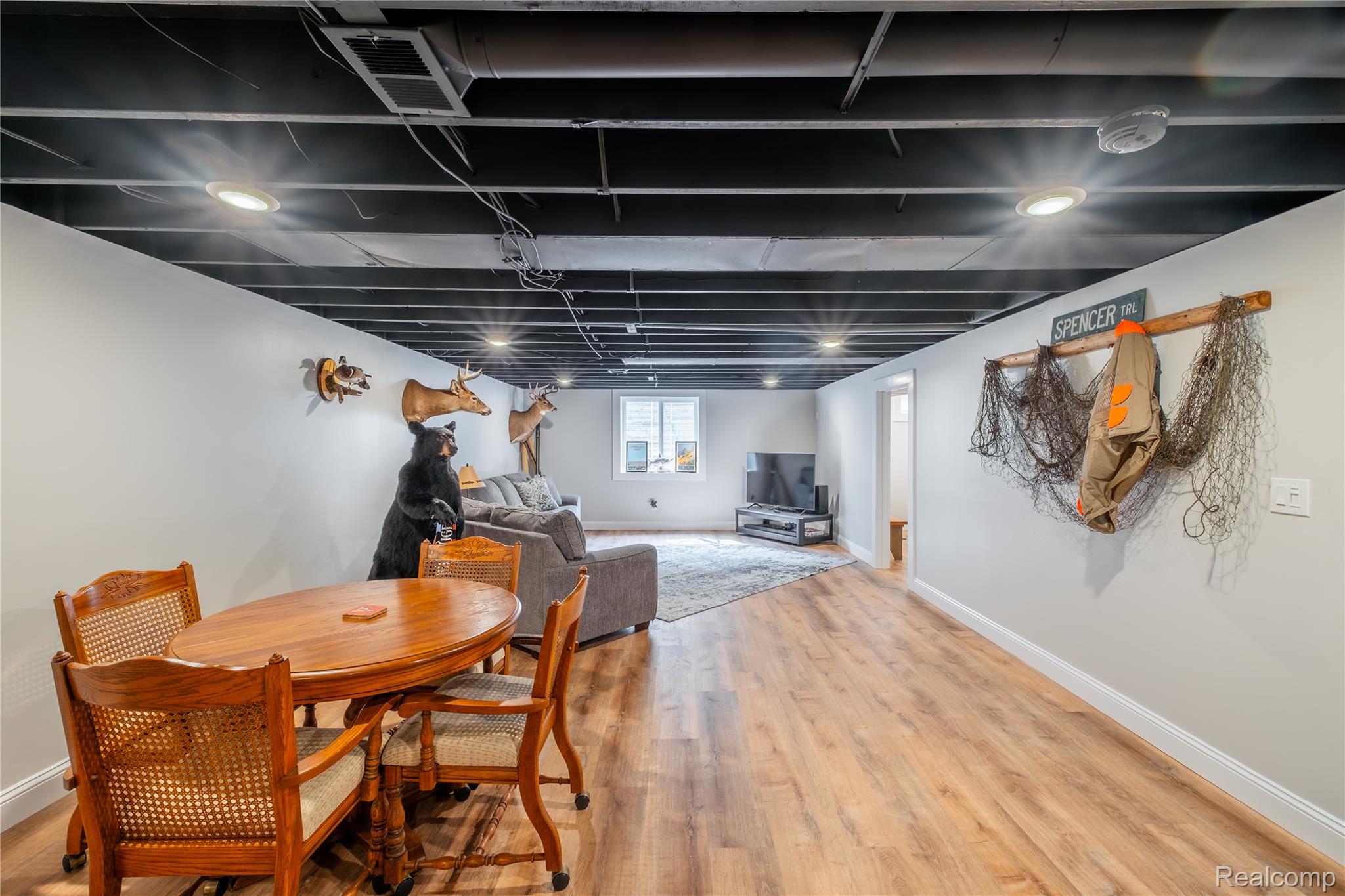 5179 East Baldwin Road Holly, MI 48442 - Photo 16 of 30 Finished basement featuring exposed ceiling with recessed lighting, wood-finish flooring throughout, and ample square footage suitable for multiple uses