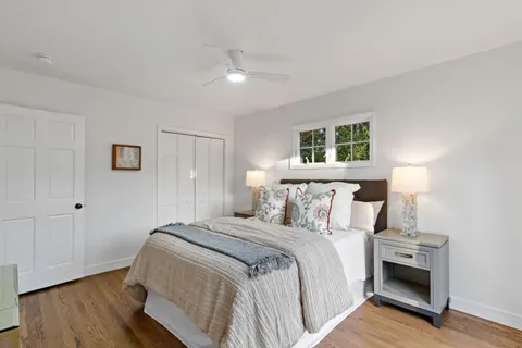 a bedroom with a bed and a night stand