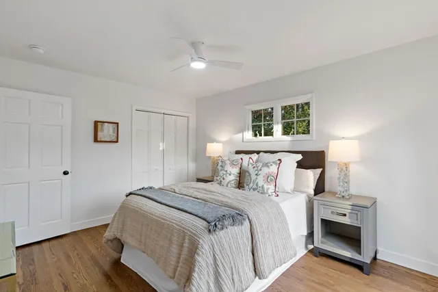 a bedroom with a bed and a night stand