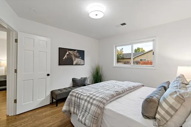 a bedroom with bed and a window