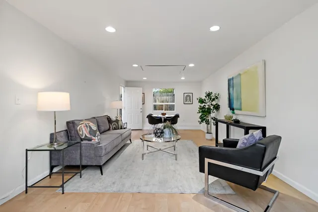 a living room with furniture and a lamp