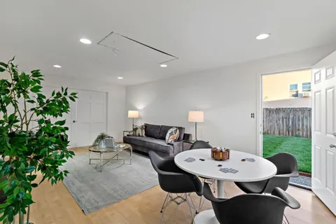 a living room with furniture and a potted plant