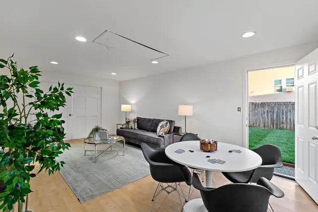 a living room with furniture and a potted plant