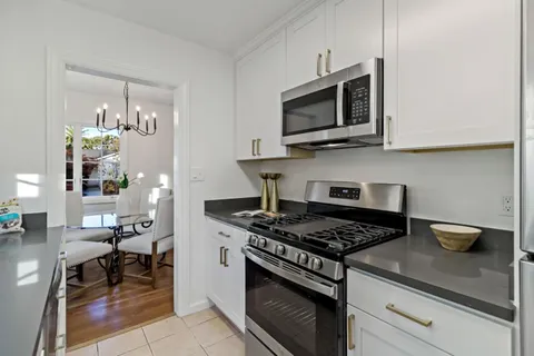 a kitchen with stainless steel appliances granite countertop a stove and a microwave