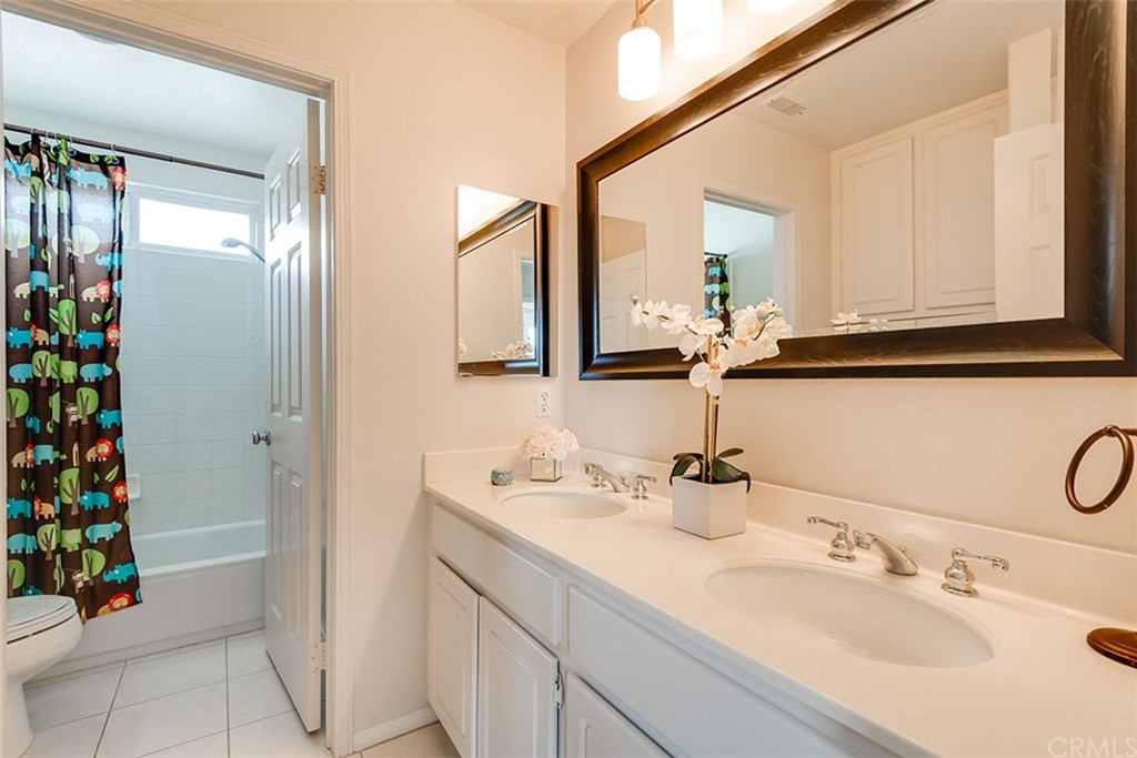 27952 Rural Lane Laguna Niguel, CA 92677 - Photo 18 of 28 a bathroom with a sink vanity and mirror