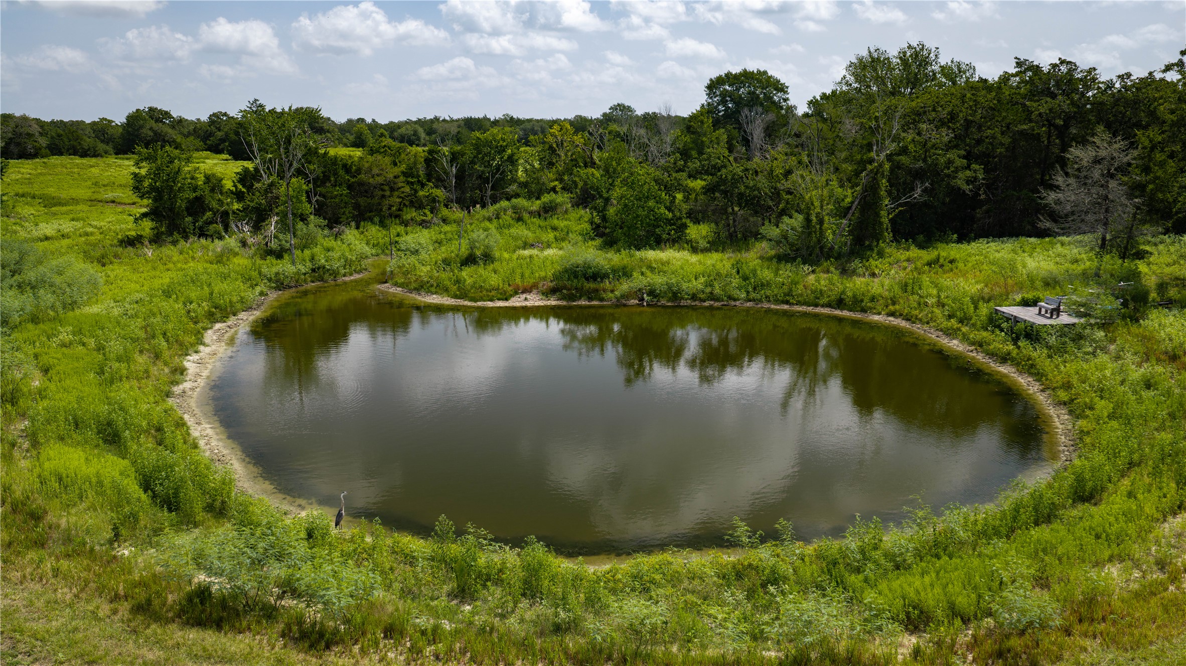 7221 West Old Lockhart Road Muldoon, TX 78949 - Photo 1 of 38 A tranquil private pond is surrounded by dense mature trees and grassy meadows.